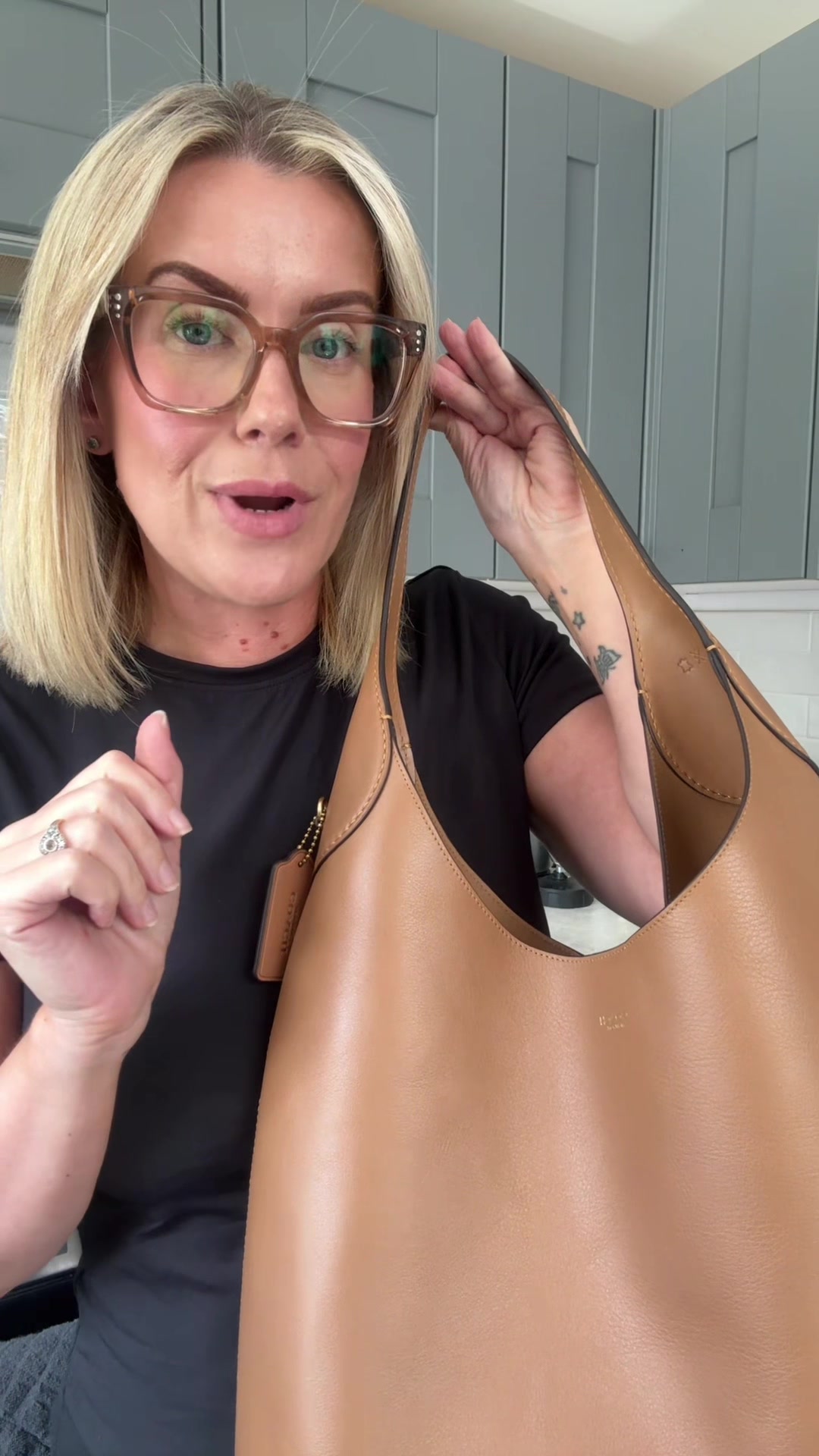 TikTok post by @daniellawears for Jimmy's Iced Coffee. Caption reads: [...] 👌🏼🫶🏼 #whatsinmybag #workbag....