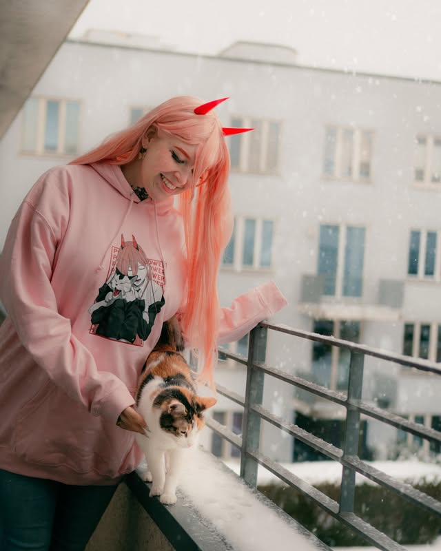 Instagram post by @marrytulip_ for CosPositive. Caption reads: Power and Meowy enjoying the snow ❄️ My fav art....