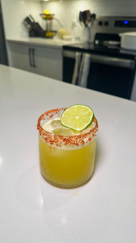 Instagram post by @wholesomefoodbykatie for Ritual Zero Proof. Caption reads: Coconut Mango Margarita 🥥🥭 made non-alcoholic....
