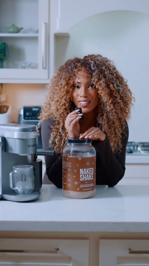 Instagram post by @suzette_james for NAKED nutrition. Caption reads: Hot cocoa, but make it protein with....