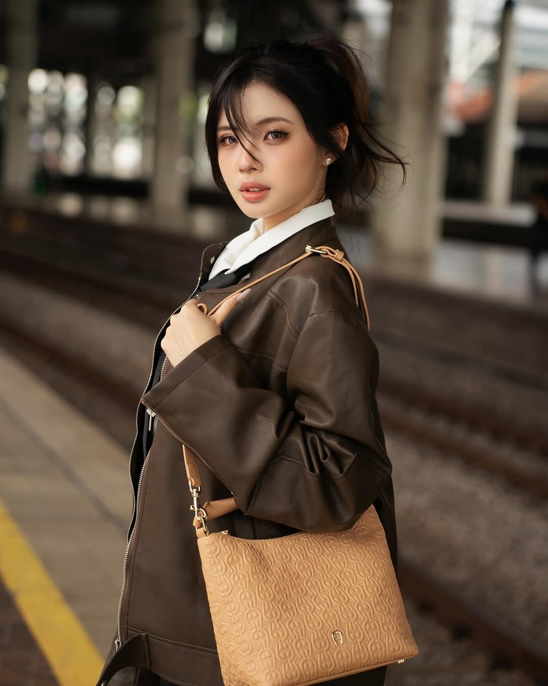 Instagram post by @nyokki.ho for Etienne Aigner AG. Caption reads: New Year, New Vibes, New Luxury. 
Celebrating....