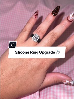TikTok post by @jadeealeyah for Rinfit. Caption reads: [...] #EngagementRing #EmeraldCutRing #RinfitRing....