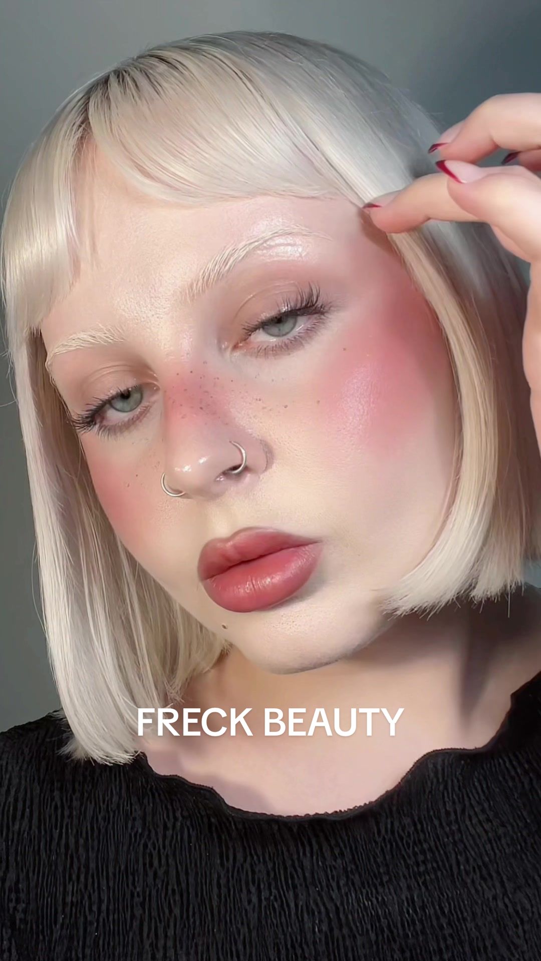TikTok post by @blondetaki for Freck Beauty. Caption reads: Pomegranate makeup with @Freck Beauty 🍇🍓🍒....