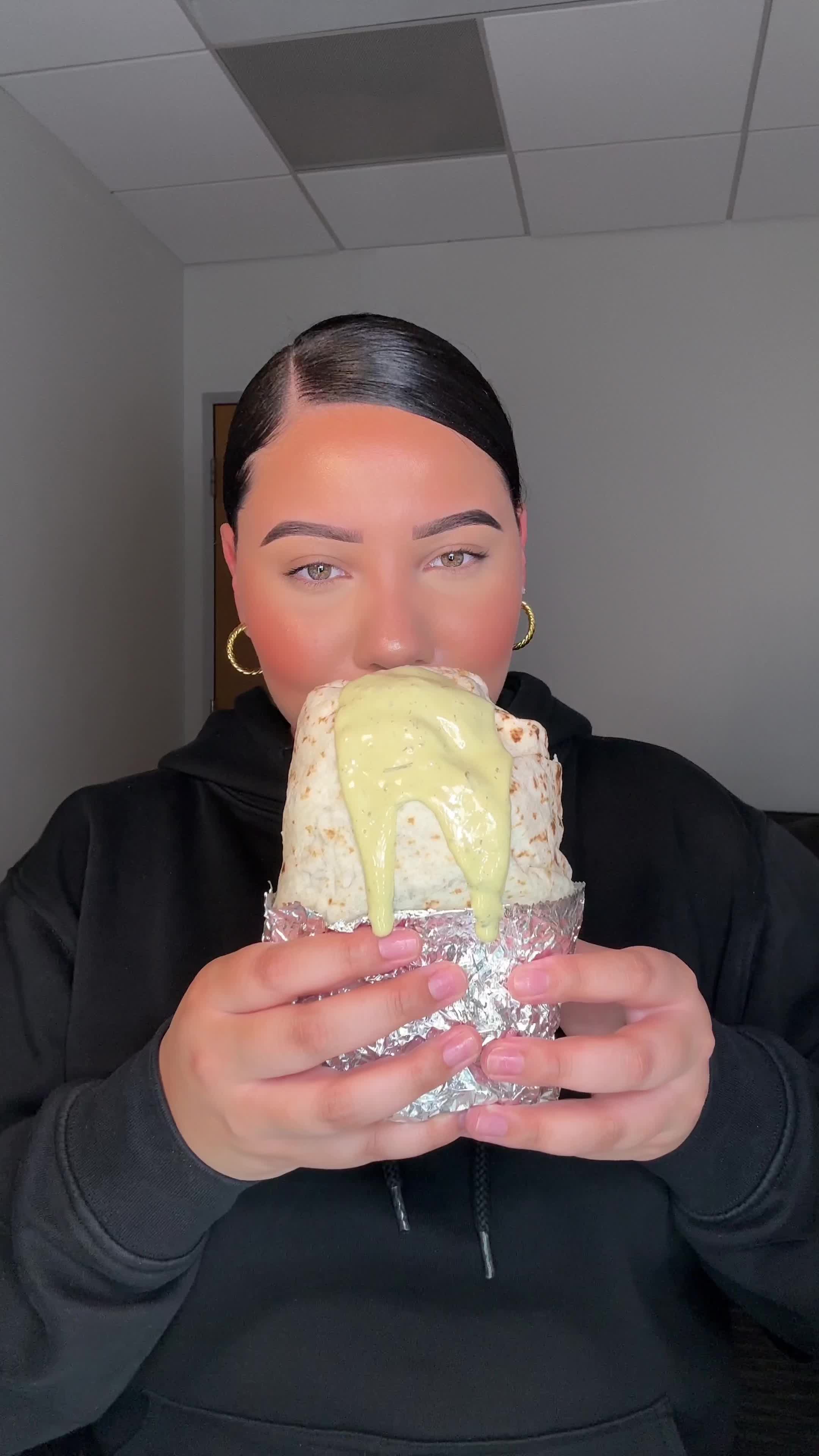 TikTok post by @claudiaeatsgood for Mark's Daily Apple. Caption reads: #ad HUGE spicy chicken burrito 🌯 paired perfectly....