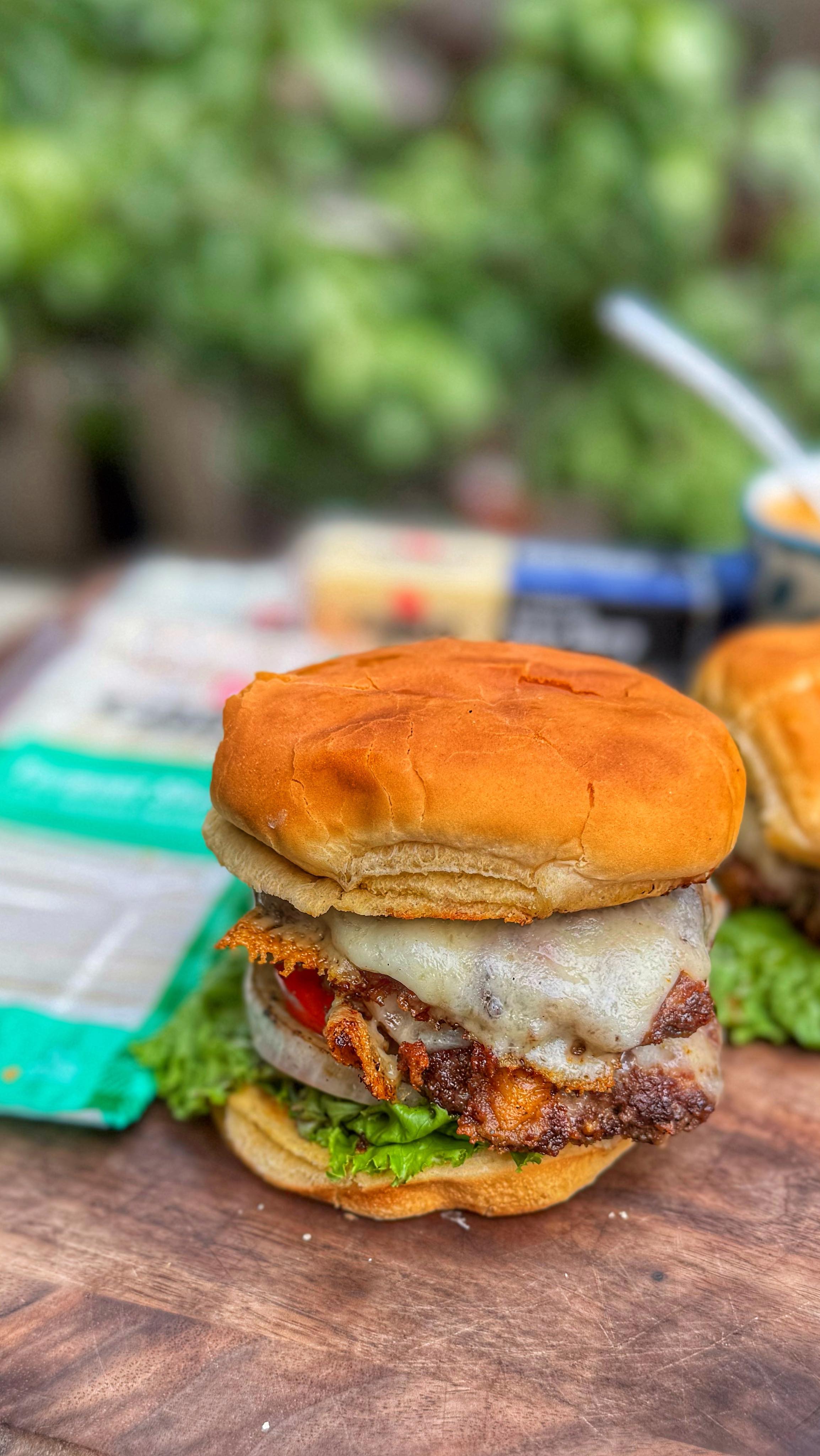 Instagram post by @thisjewcanque for Cabot Creamery Cooperative. Caption reads: 🍔 Happy National Cheeseburger Day! We’re....