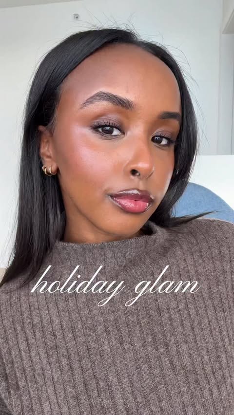 Instagram post by @emanosmann for Milani Cosmetics. Caption reads: When the holiday glam starts with a flawless base....