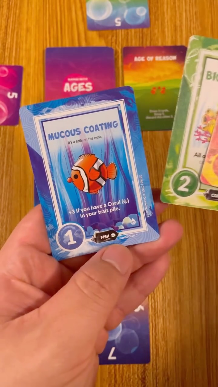 Instagram post by @tiktokboardgames for Doomlings. Caption reads: [...] as well take a vacation 🌊🏝️👙☀️ Doomlings....