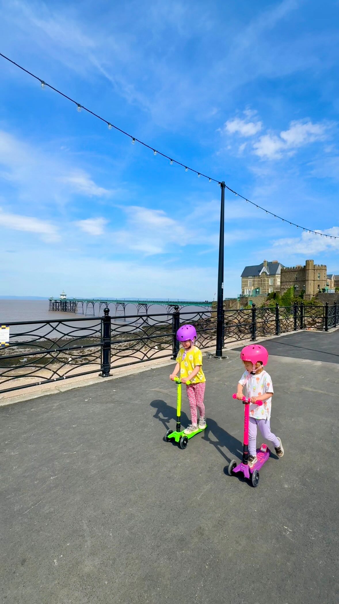 Instagram post by @bristolfamilyblog for Micro Scooters UK. Caption reads: Clevedon seafront with @microscooters! 🐚 Read....