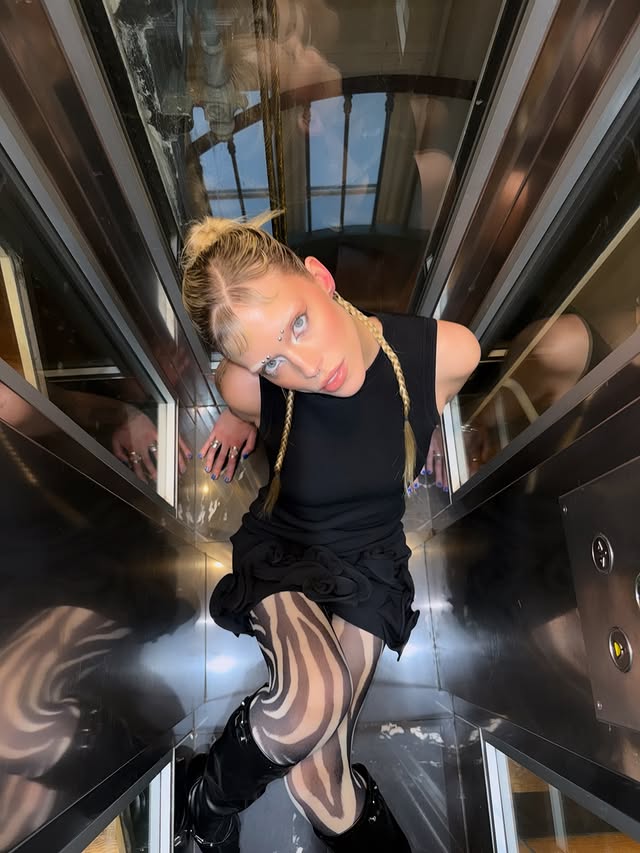 Instagram post by @lucidleslie for Sandro Paris. Caption reads: stopping elevators in paris in @sandroparis shot....