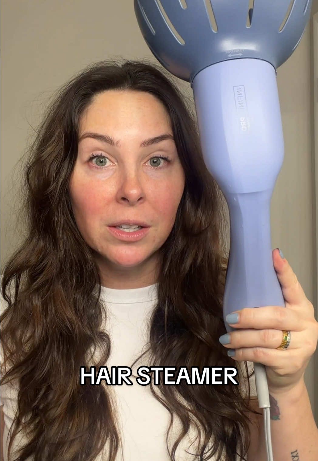 TikTok post by @katiesantry for Conair. Caption reads: [...] InfinitiPRO handheld hair steamer by @Conair....