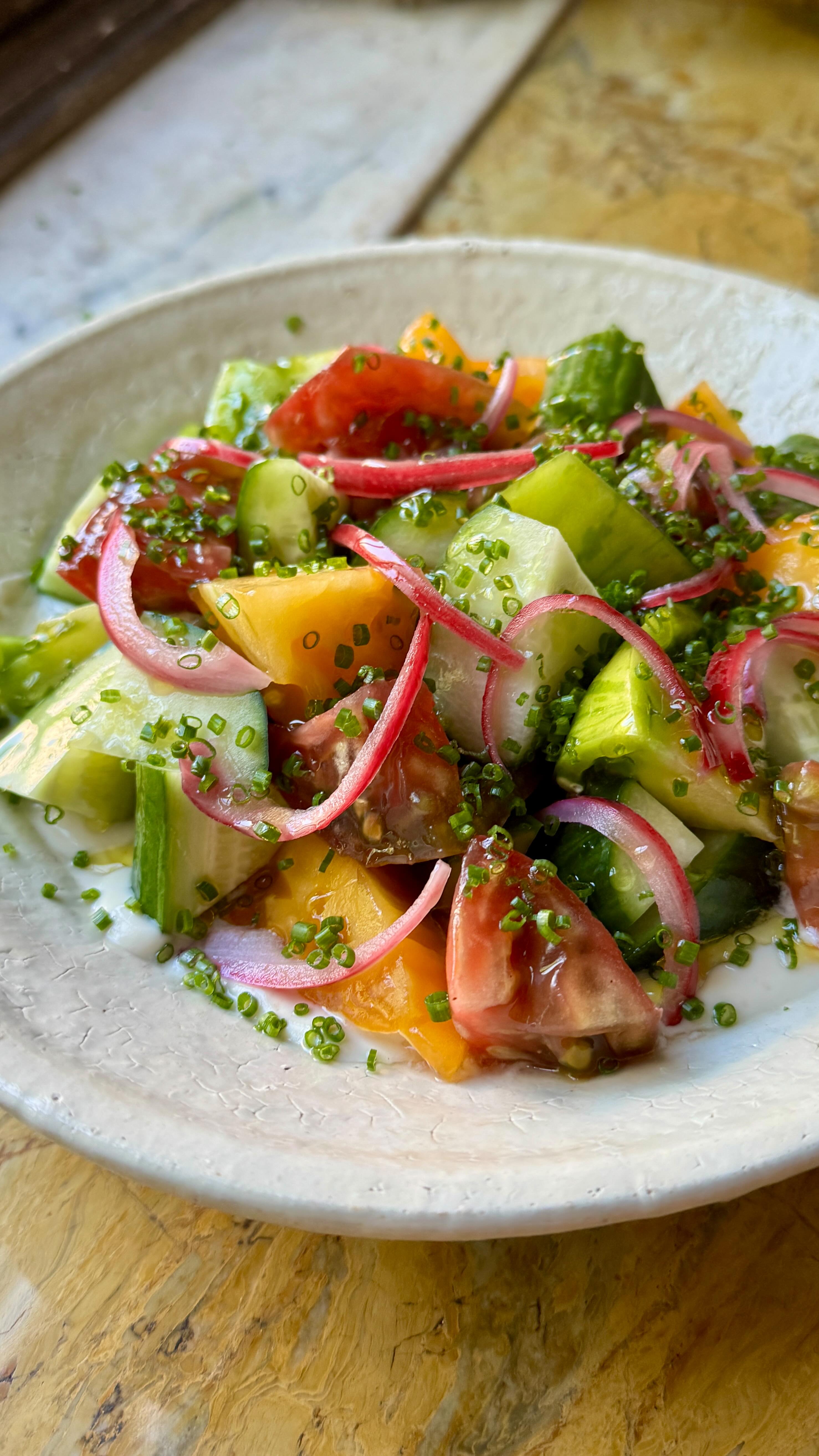 Instagram post by @pierceabernathy for NYT Cooking. Caption reads: Cucumber-Tomato Salad with Sesame Whipped Tofu. My....