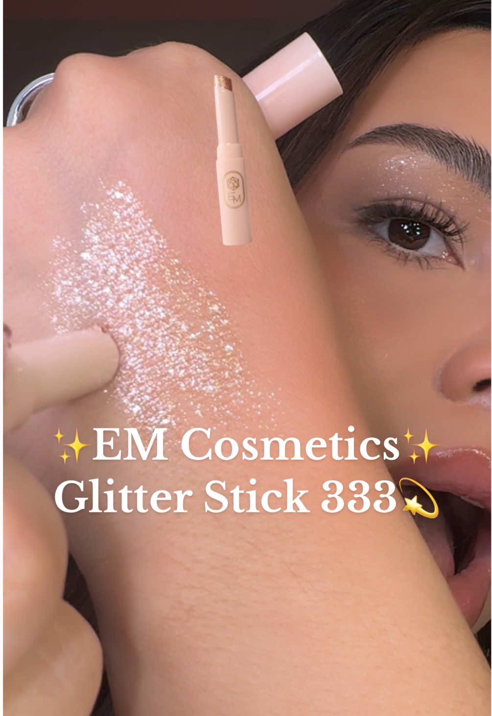 TikTok post by @deesibrian for EM Cosmetics. Caption reads: [...] Jelly textured glitter stick 😍 @EM....