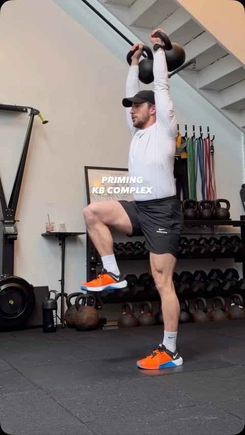 Instagram post by @darrentomasso for Nike. Caption reads: [...] x5 KB Push Press x5 Overhead March x10....