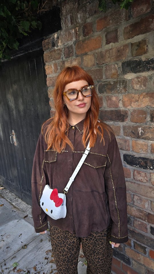 Instagram post by @amyymaggie for Cambridge Satchel. Caption reads: Autumn is jacket (and oat milk latte) season!....