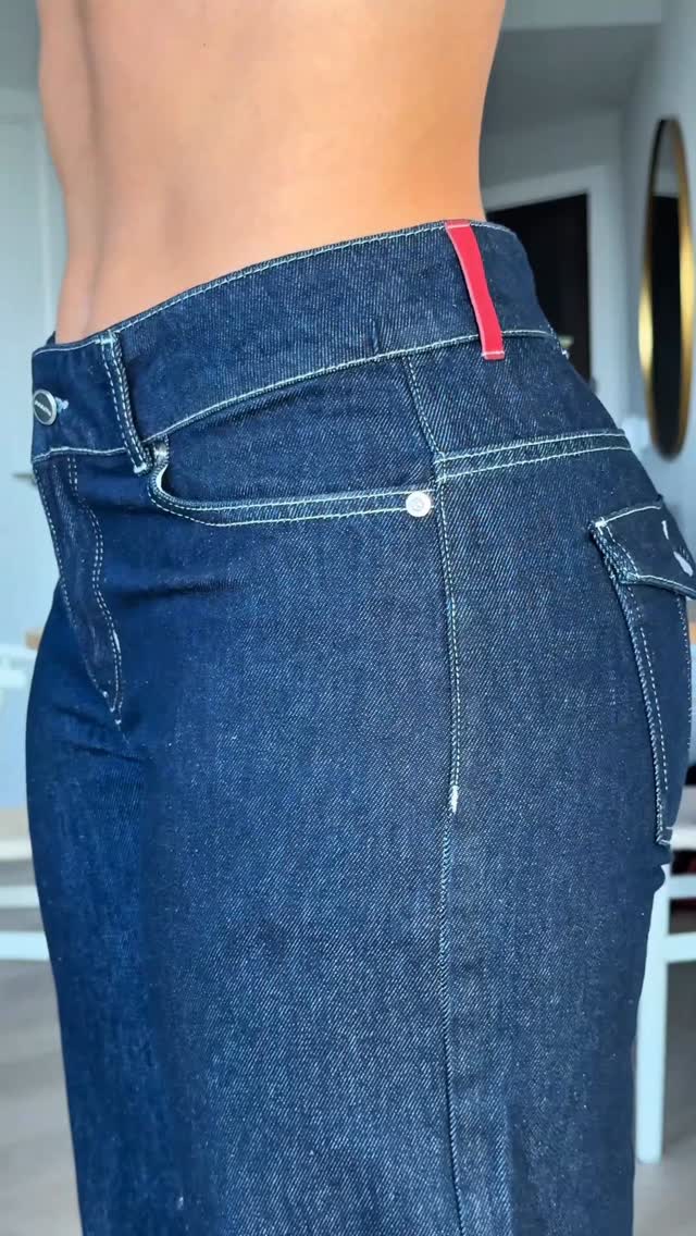 Instagram post by @livefitelle for JW ANDERSON. Caption reads: ad White tee, blue jeans & a strong scent....