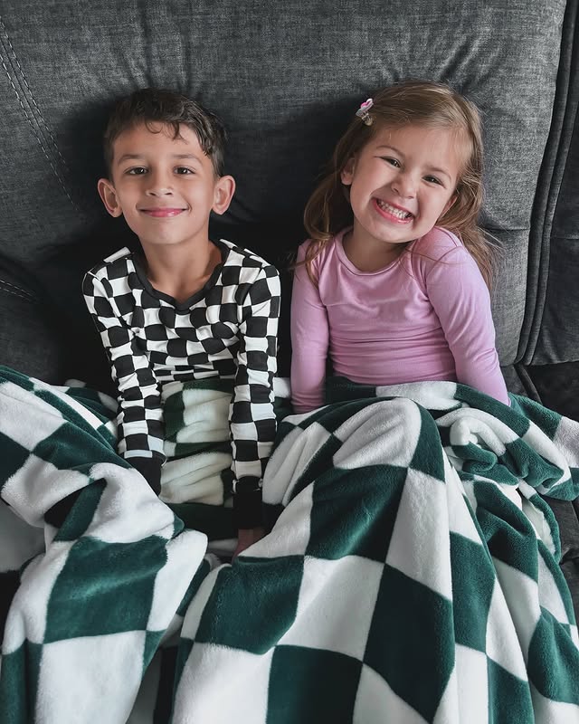 Instagram post by @marissa.charlotte for Dreamland Baby. Caption reads: My littles in their @dreamlandbabyco PJs 🌸🏁 •....