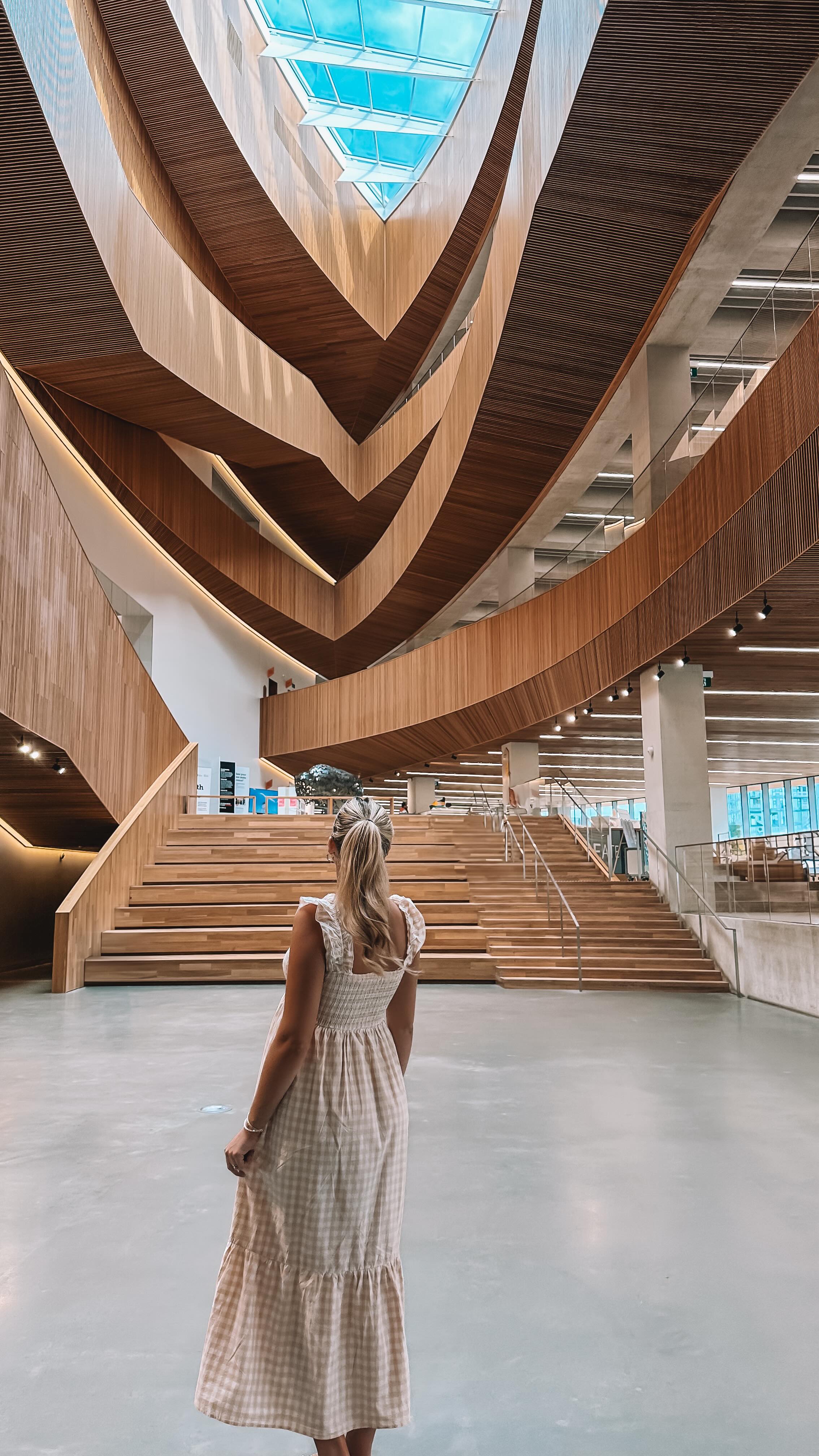Instagram post by @kalialexandria for Tourism Calgary. Caption reads: ✨ Calgary has a library that feels more like a....