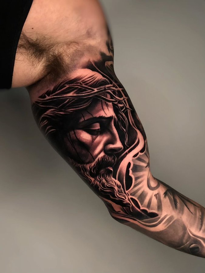Instagram post by @mager_tattoos for Affirm. Caption reads: Inner arm Jesus piece to complete this sleeve. |....