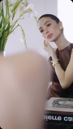 Instagram post by @izasim for Valextra. Caption reads: Let me show you what completes todays LOOK🤎
....