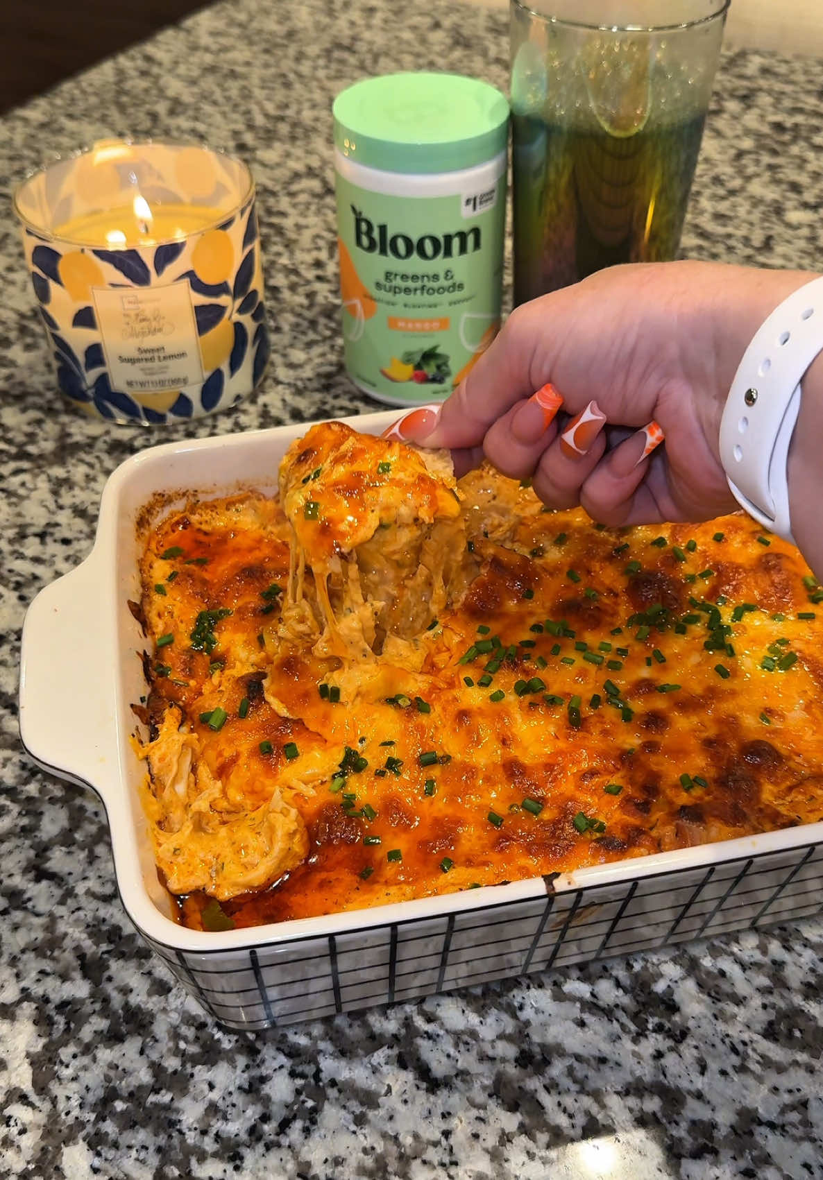 TikTok post by @cookinwithmegg for Bloom Nutrition. Caption reads: The best buffalo chicken dip ever! Washed down....