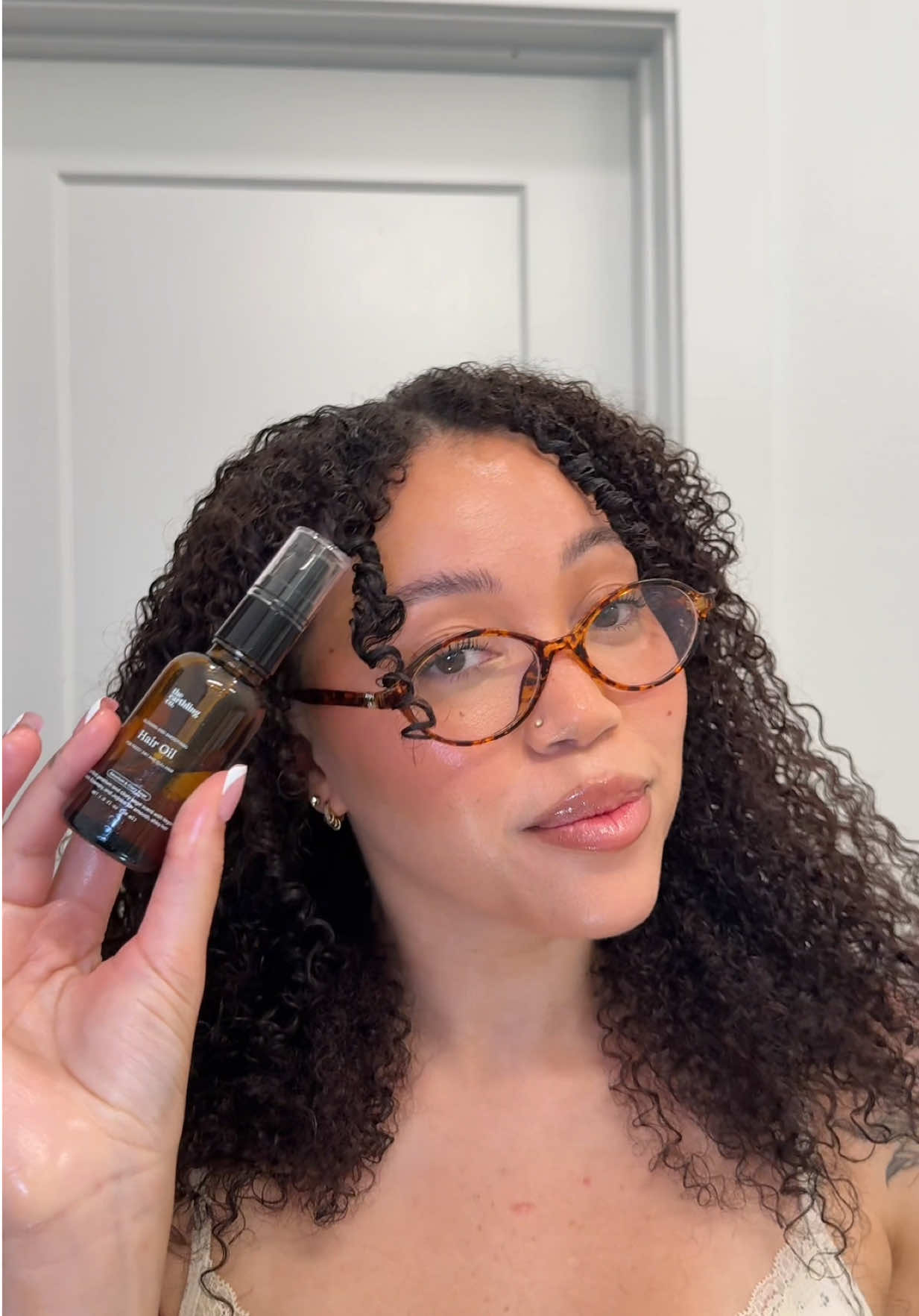 TikTok post by @alohabriee for The Earthling Co.. Caption reads: [...] my curls ✨ I’ve been incorporating @The....