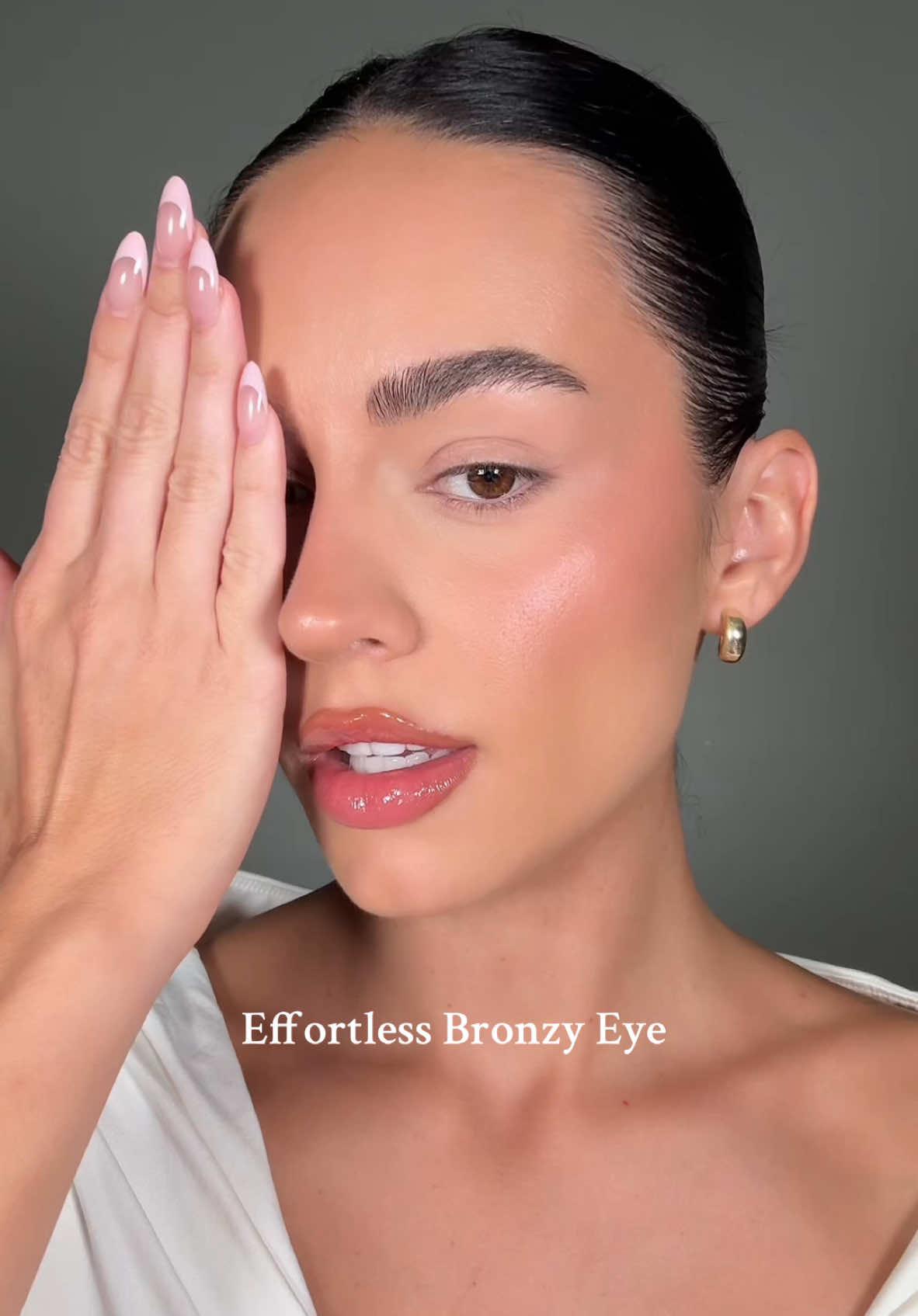 TikTok post by @danielllestrada for Laura Mercier. Caption reads: Bronzy eyes using the @Laura Mercier caviar....