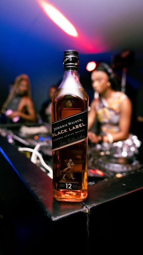 Instagram post by @chels_sloan for Johnnie Walker. Caption reads: Pouring into my journey . One show at a time with....