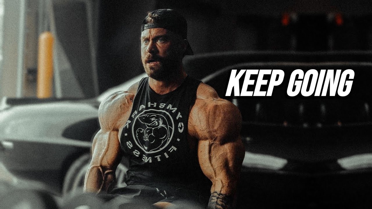 YouTube post by @MuscleBrawn for ENHANCED Labs. Caption reads: KEEP GOING WHEN YOU WANT TO QUIT - Gym Motivation....