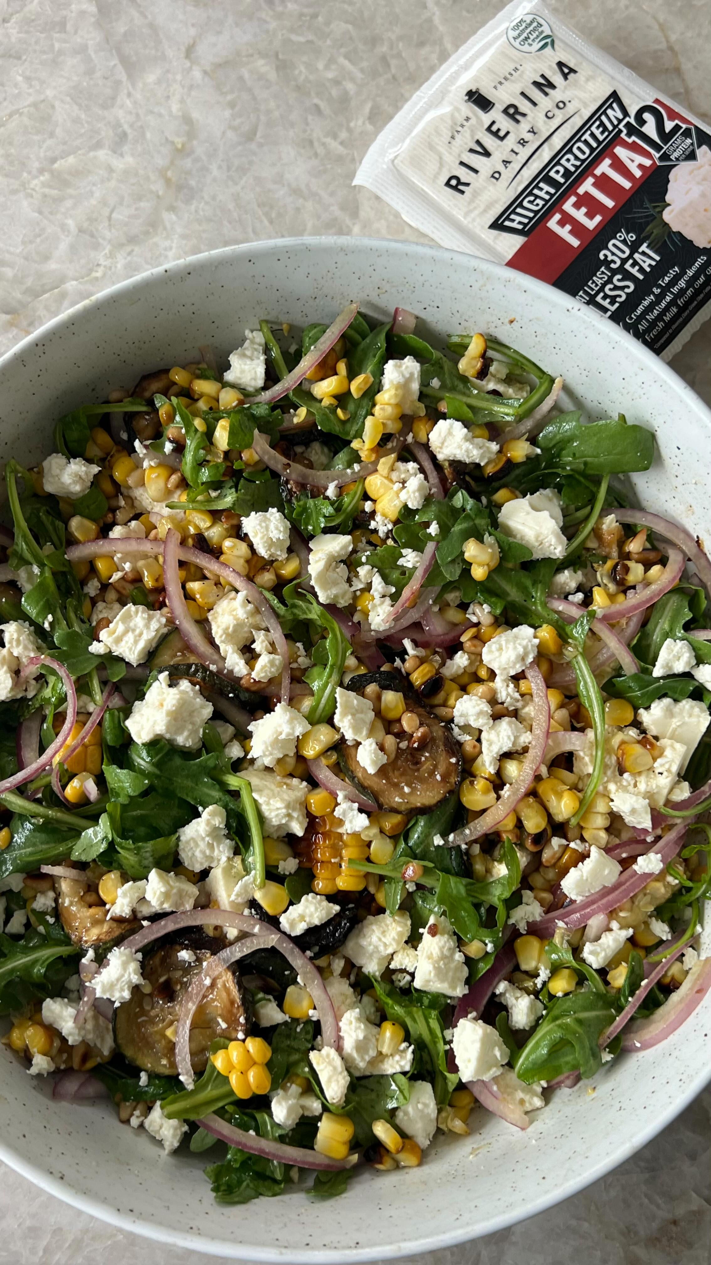 Instagram post by @nourish_naturally for Woolworths. Caption reads: Let’s make my viral Charred Corn, Fetta & Zucchini....