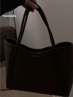 TikTok post by @val.leigh for Newbella Fashion. Caption reads: The perfect fall fits everything bag🍂🤎🤎....