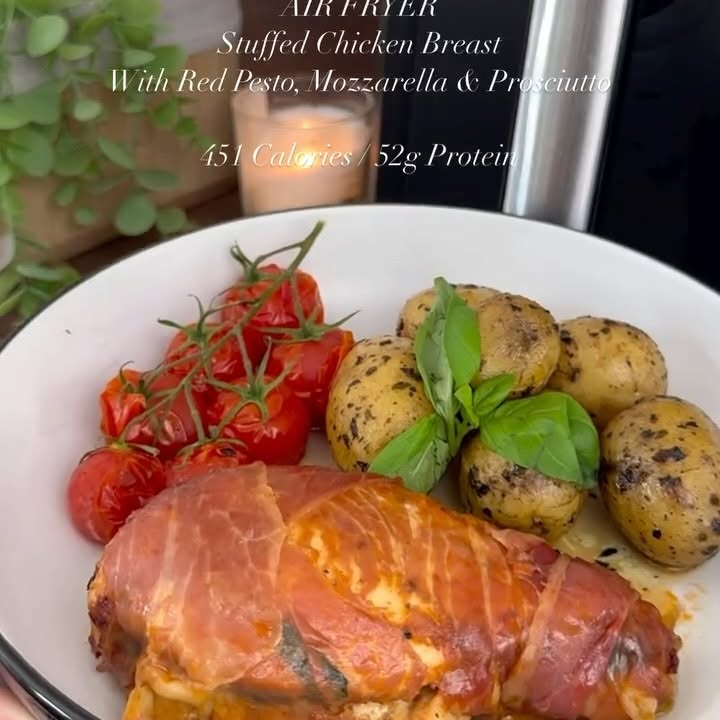 Instagram post by @slimming.gym.and.gin for The Skinny Food Co. Caption reads: Recipe in caption ⬇️ Air Fryer Stuffed Chicken....