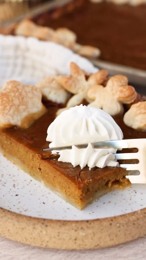 Instagram post by @milkandcardamom for Taste of Home. Caption reads: This Pumpkin Slab Pie with Cranberry Jam Swirl....