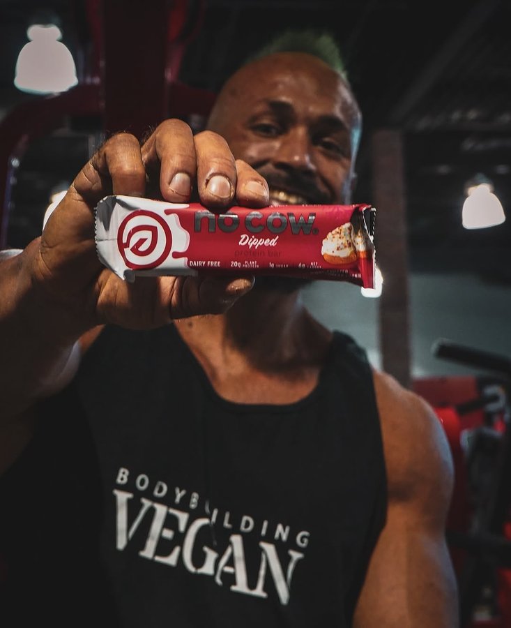 Instagram post by @thebodybuildingvegan for No Cow. Caption reads: #sponsored @nocow are you Team Dipped or Team....