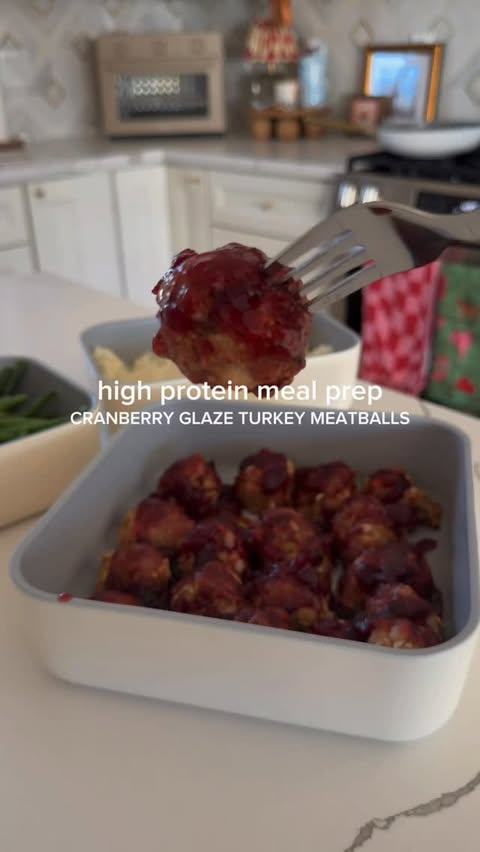 Instagram post by @__balancedwithbritt for Caraway Home. Caption reads: a festive little meal prep! these cranberry glaze....