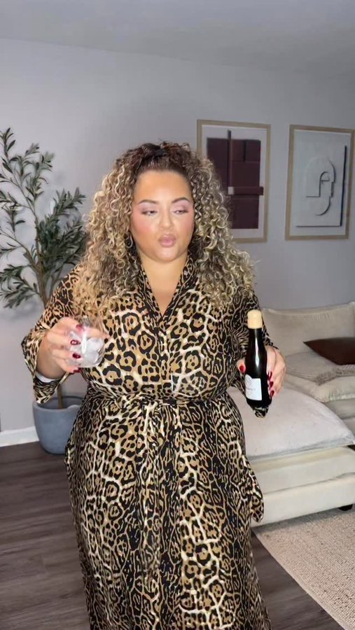 Instagram post by @scoutureox for ELOQUII. Caption reads: Had to pop my prosecco open to get in the mood!....