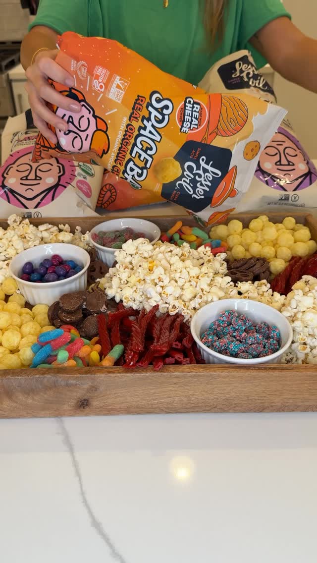 Instagram post by @camenyoungblood for LesserEvil Kids. Caption reads: Making a movie night snack board with all of our....