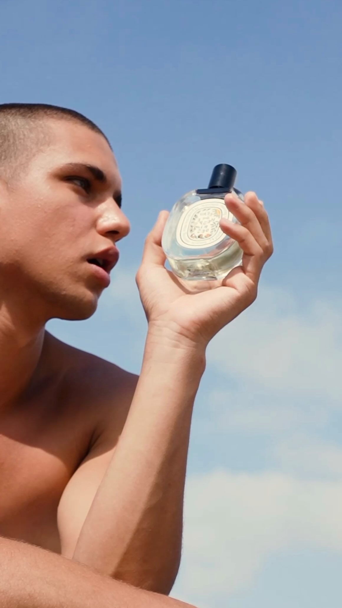 Instagram post by @artem_den for Diptyque. Caption reads: Salty skin, citrus breeze, and sun-warmed....