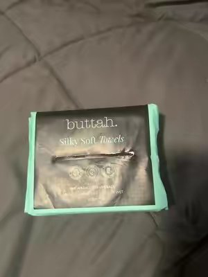TikTok post by @brandiv03 for Buttah Skin. Caption reads: [...] Grab yours in the TikTok Shop! 🛒@Buttahskin....