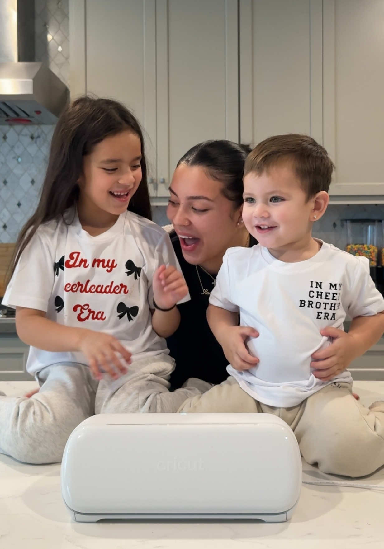 TikTok post by @makeala_cachola for Cricut. Caption reads: [...] 🎀 Making custom cheer shirts with my....
