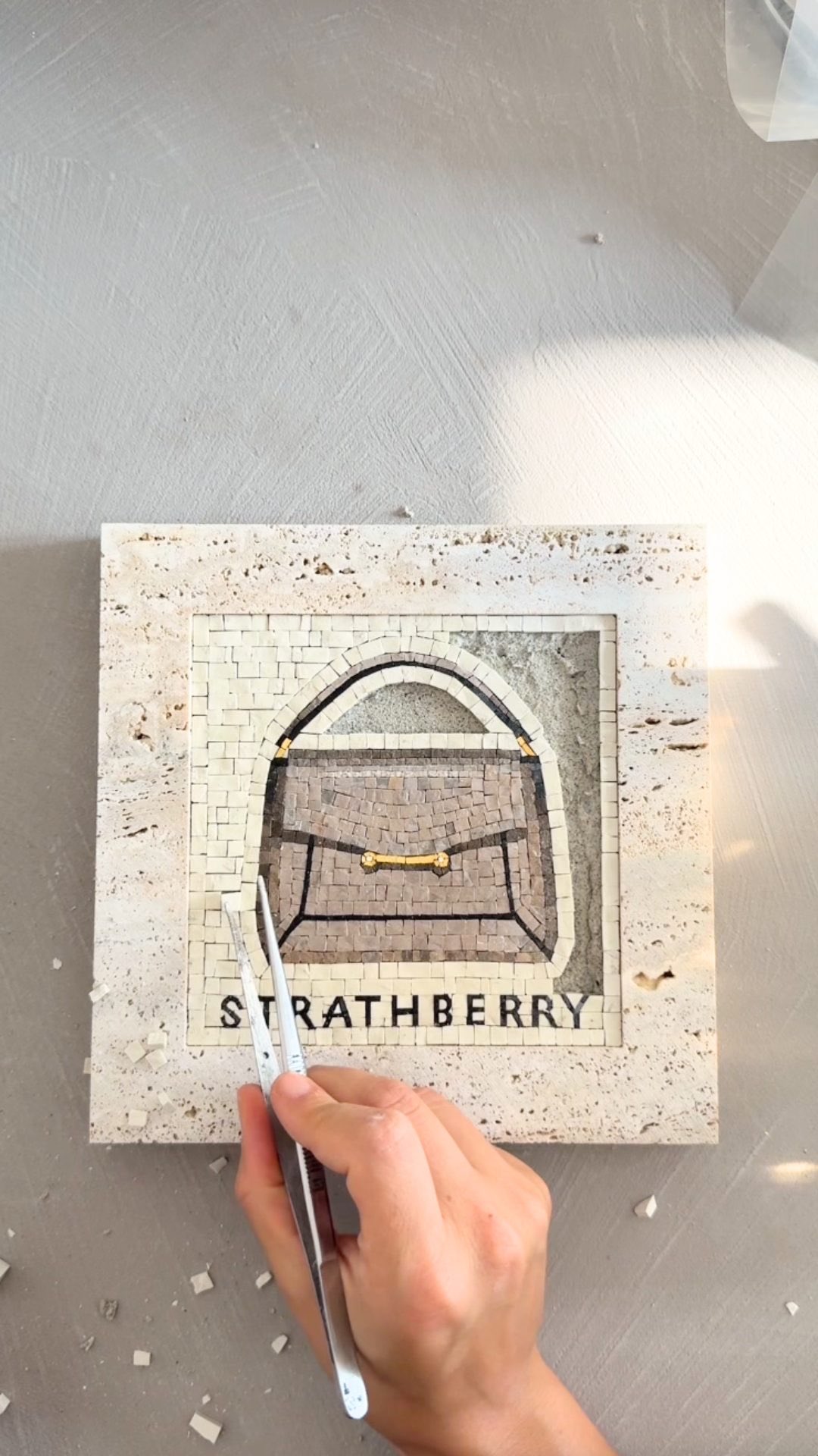 Instagram post by @asaroton for Strathberry. Caption reads: The Strathberry Mosaic, captured in mosaic.....