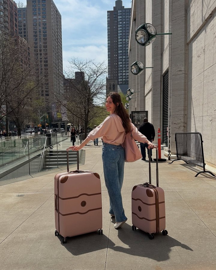 Instagram post by @tilerpeck for DELSEY PARIS. Caption reads: My DELSEY PARIS luggage is on pointe! 🩰 The....