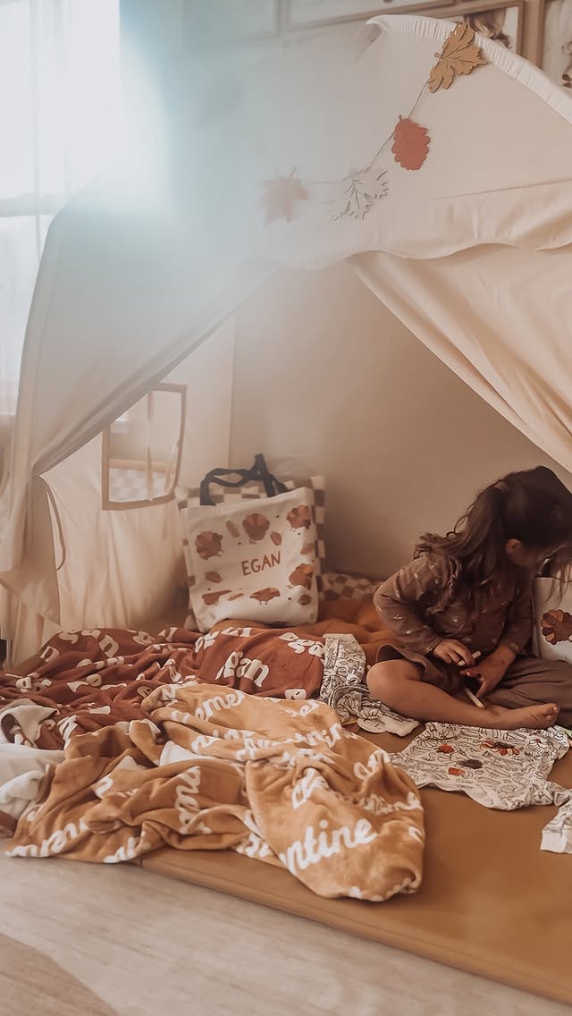 Instagram post by @ashlee_kaila for Caden Lane. Caption reads: The kids think this is just a cozy fall tent....