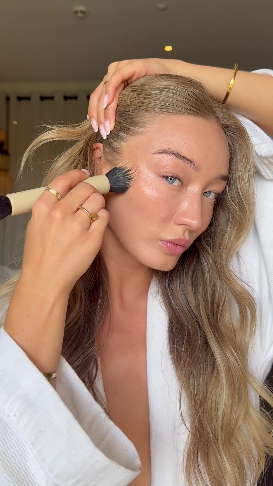 TikTok post by @bethansowerbyy for Lookfantastic. Caption reads: Dewy skin + bronzey base = perfect holiday combo....