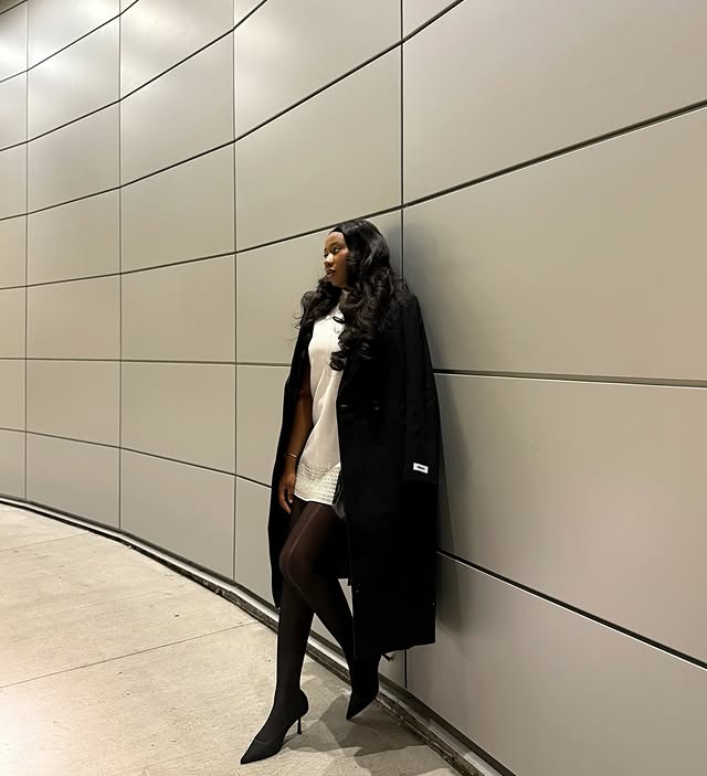 Instagram post by @preetyomahs_world for DKNY. Caption reads: Moving quietly, shining loudly.
Coat: @dkny 
#OOTD....