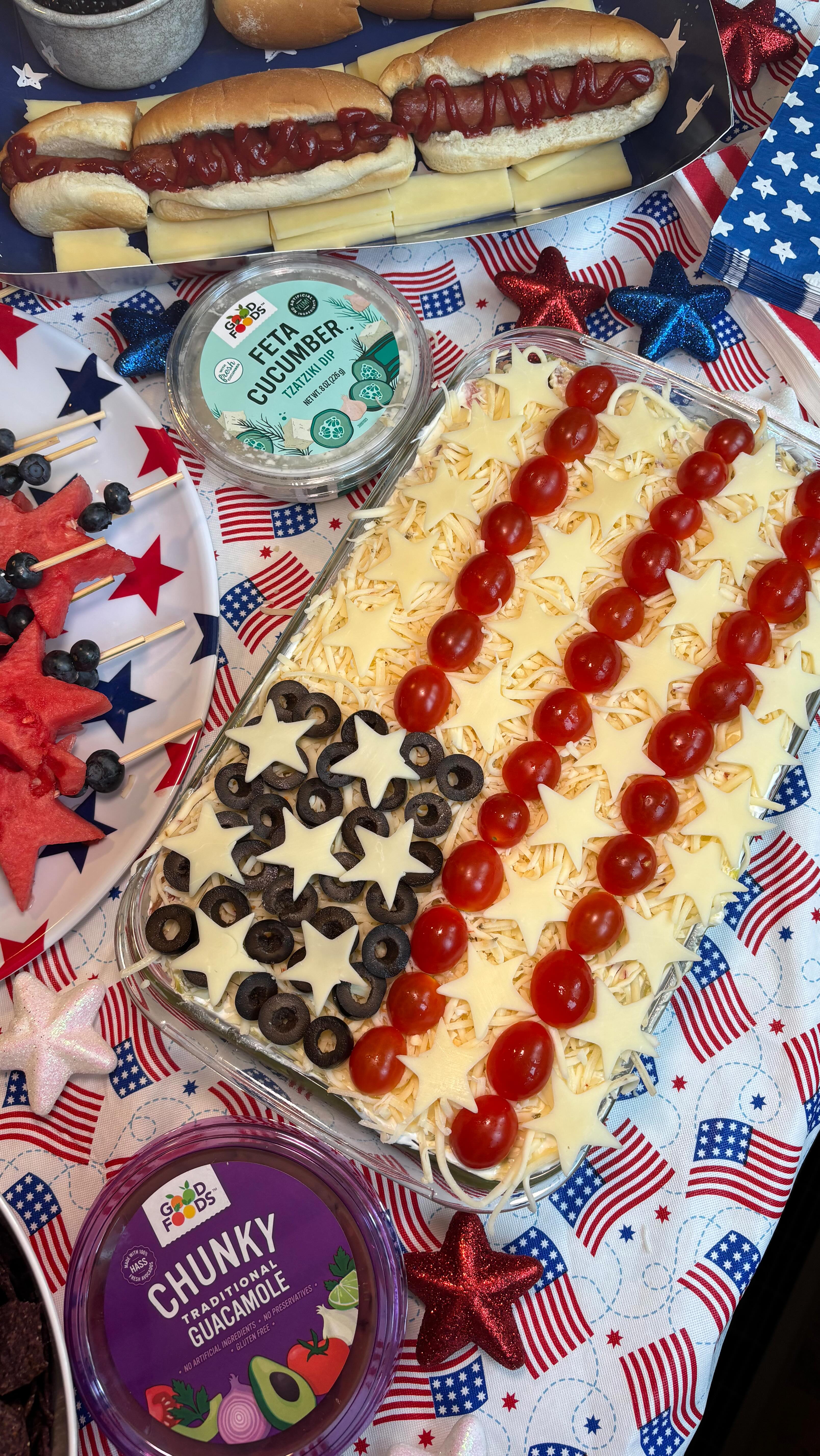 Instagram post by @tastewithnicki for Good Foods. Caption reads: 7 Layer Taco Dip🥑🇺🇸

This 10 minute 4th of July....