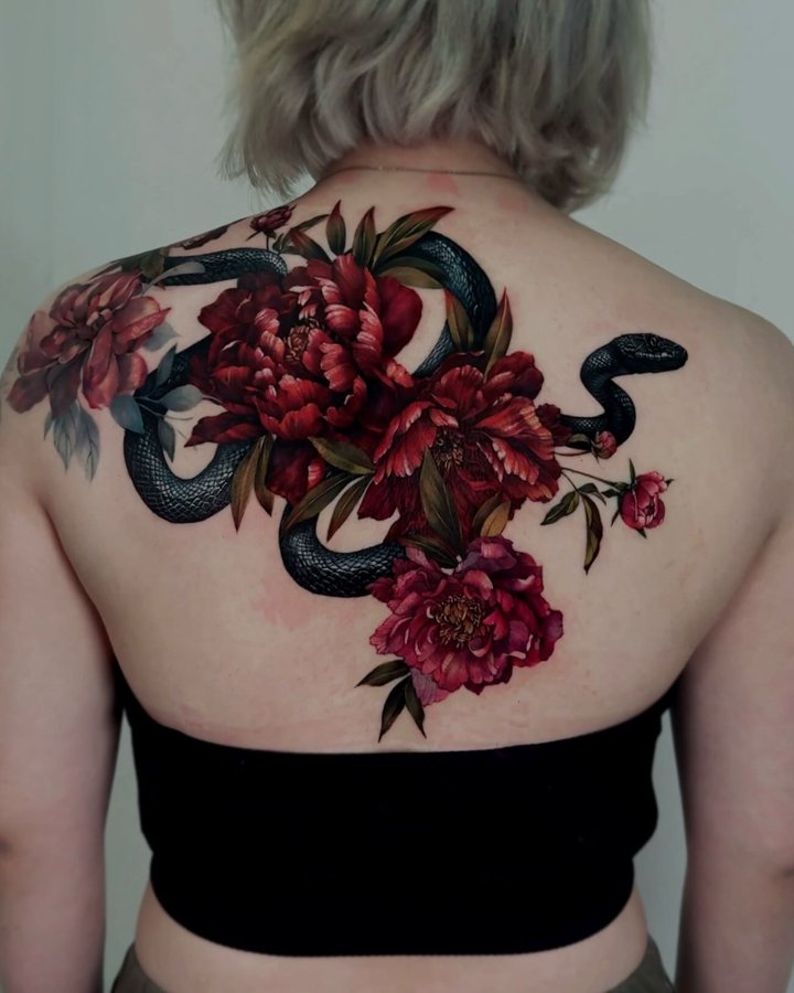 Instagram post by @chou_tatt for EZ Tattoo Supply. Caption reads: The design extends up to the trapezius.
The total....