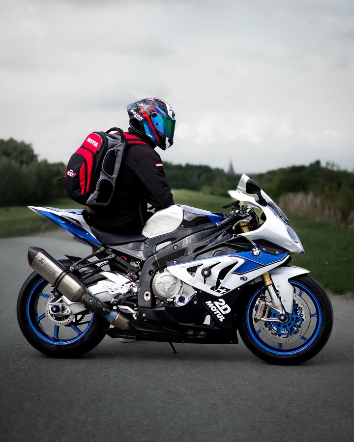 Instagram post by @reflix32 for BMW Motorrad. Caption reads: @motul on the back, Akrapovič on the side, powered....