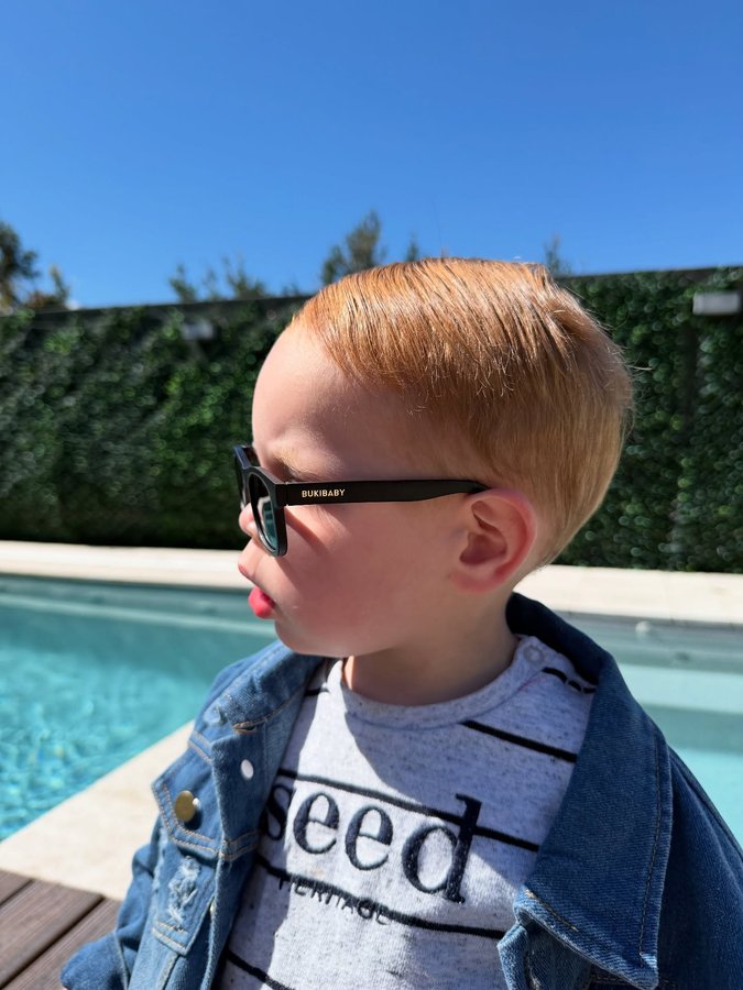 Instagram post by @huddyandme for Polarised Baby Sunglasses. Caption reads: Too cool for school 🕺🕺 Wearing....