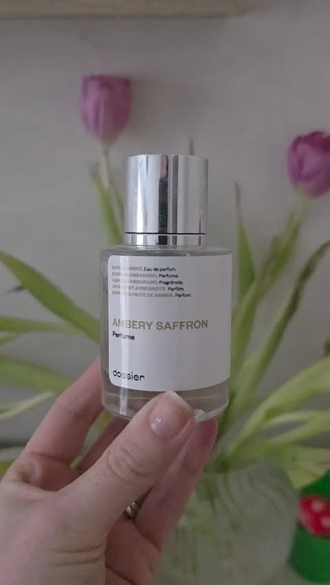 Instagram post by @thewoodwardsworld_ for Dossier. Caption reads: [...] favourite fragrance of 2025 into 2026 thanks....