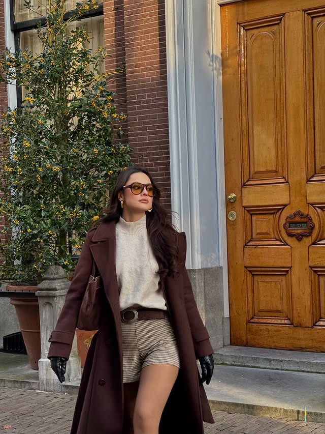 Instagram post by @simgeakman for Trendyolmilla. Caption reads: brown tones & Dutch streets🍂🏘️🤎 #reklam.